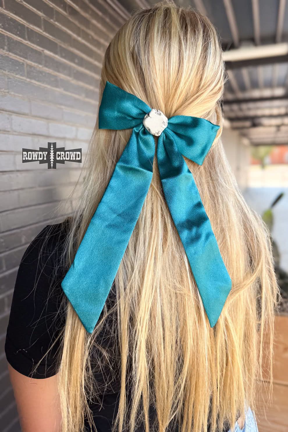 Blue bow with white stone